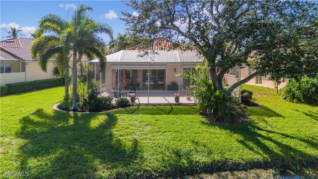 rear view of property with a yard