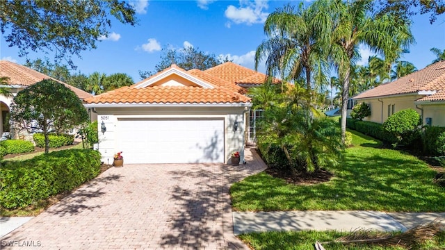 mediterranean / spanish house featuring a front lawn and a garage