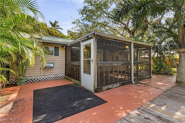 view of outbuilding with a sunroom