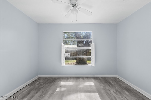 unfurnished room with ceiling fan and dark wood-type flooring