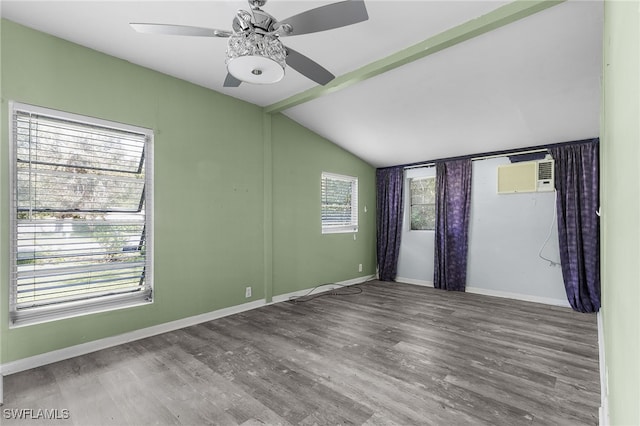 empty room featuring hardwood / wood-style flooring, an AC wall unit, ceiling fan, and lofted ceiling