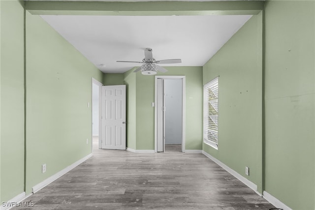 unfurnished bedroom with ceiling fan and light wood-type flooring