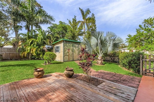 wooden terrace featuring a yard and a shed