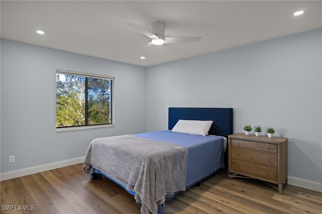 bedroom featuring hardwood / wood-style floors and ceiling fan