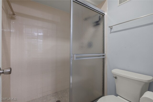 bathroom with toilet and walk in shower