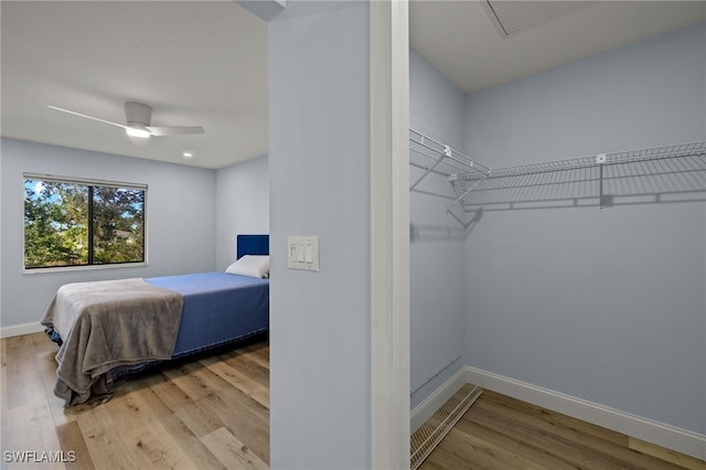 bedroom with ceiling fan and light hardwood / wood-style floors