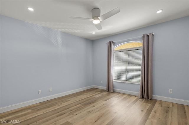 spare room featuring ceiling fan and light hardwood / wood-style floors