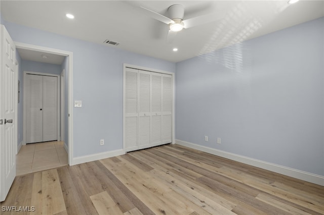 unfurnished bedroom with a closet, ceiling fan, and light wood-type flooring