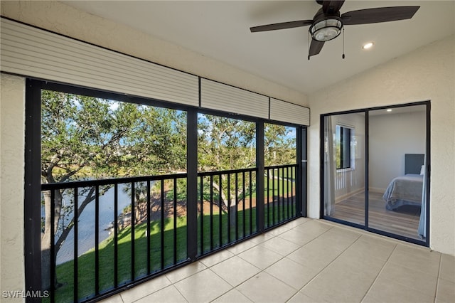 unfurnished sunroom with vaulted ceiling and ceiling fan