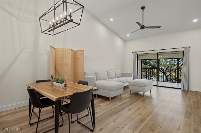 dining room with ceiling fan, high vaulted ceiling, and light wood-type flooring