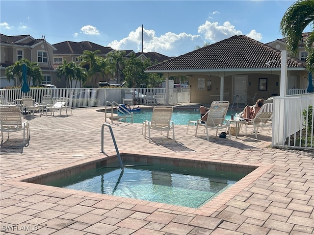 view of pool featuring a community hot tub and a patio