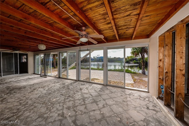 unfurnished sunroom with beam ceiling, ceiling fan, and a water view