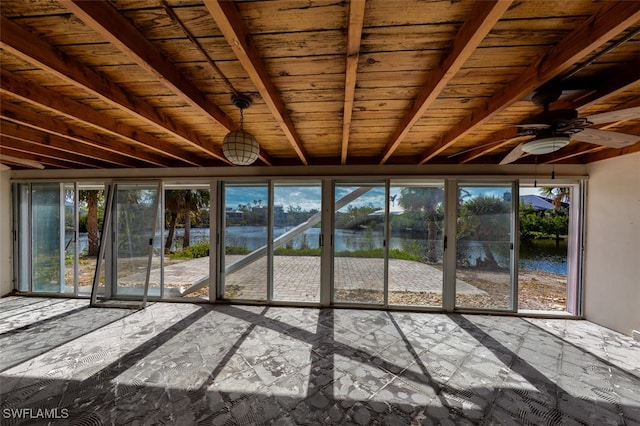 unfurnished sunroom featuring beamed ceiling, a water view, ceiling fan, and wood ceiling