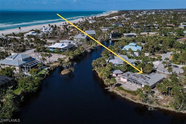 bird's eye view with a water view and a view of the beach