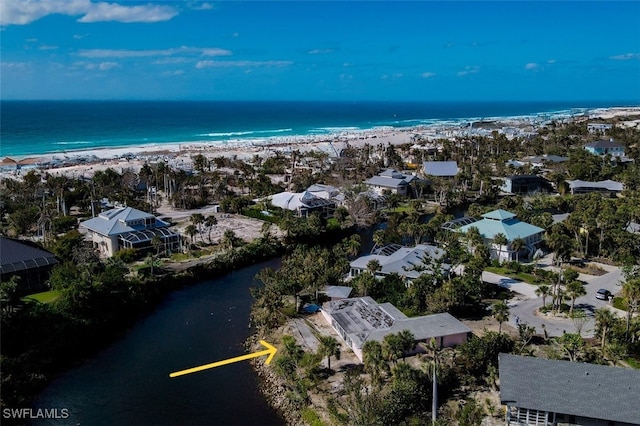 drone / aerial view with a water view and a view of the beach