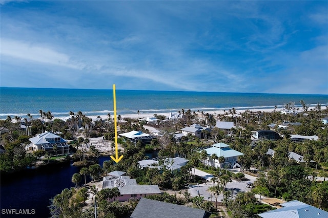 birds eye view of property featuring a water view and a view of the beach