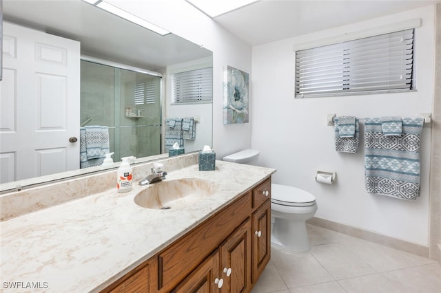 413 Augusta Blvd Unit 305, Naples, FL 34113 - bathroom with vanity, baseboards, tile patterned floors, a shower stall, and toilet