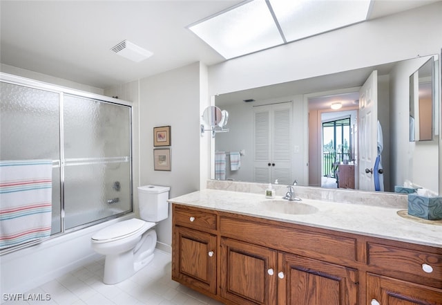 full bathroom with tile patterned flooring, vanity, toilet, and bath / shower combo with glass door