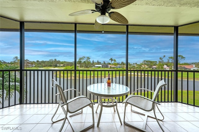 unfurnished sunroom with ceiling fan