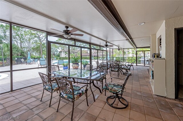 unfurnished sunroom with a wealth of natural light and ceiling fan