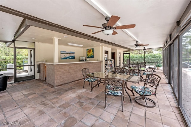 sunroom / solarium featuring ceiling fan