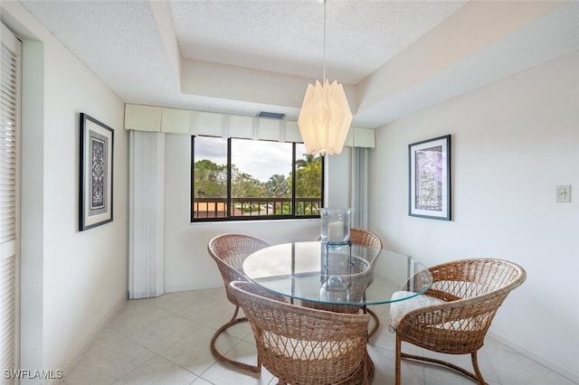 dining room featuring light tile patterned floors and a textured ceiling