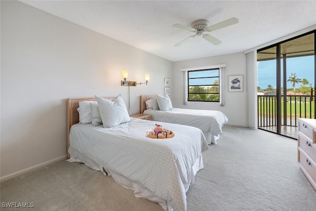 carpeted bedroom featuring ceiling fan and access to exterior