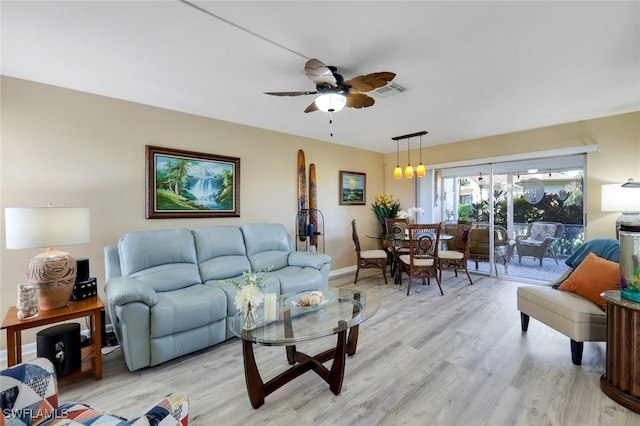 living room featuring ceiling fan and light hardwood / wood-style floors