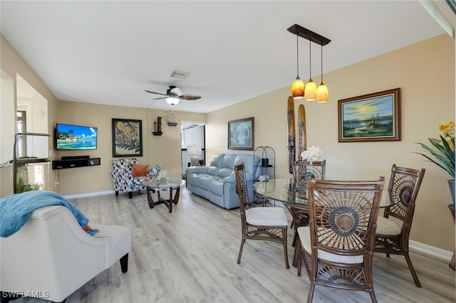 living room with ceiling fan and light hardwood / wood-style flooring