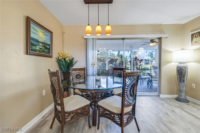 dining area with hardwood / wood-style flooring and ceiling fan