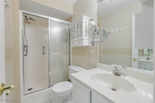 bathroom featuring vanity, an enclosed shower, and toilet