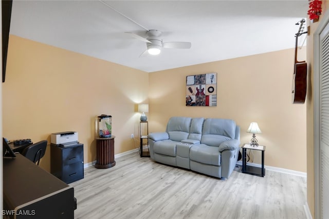 living room with ceiling fan and light hardwood / wood-style flooring