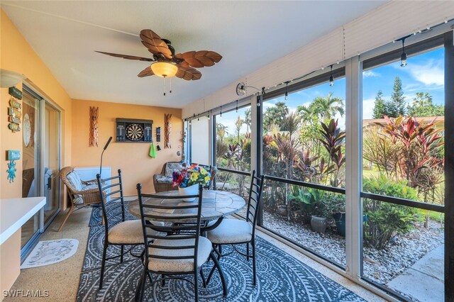 sunroom featuring ceiling fan