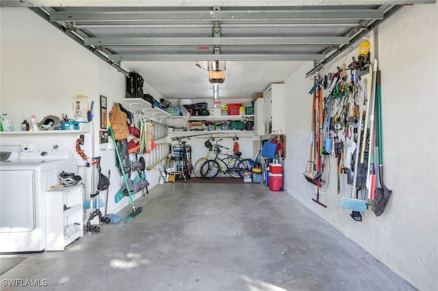 garage with washer and dryer and a garage door opener