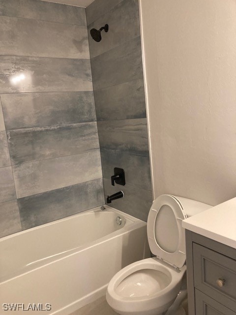 full bathroom featuring vanity, toilet, and tiled shower / bath