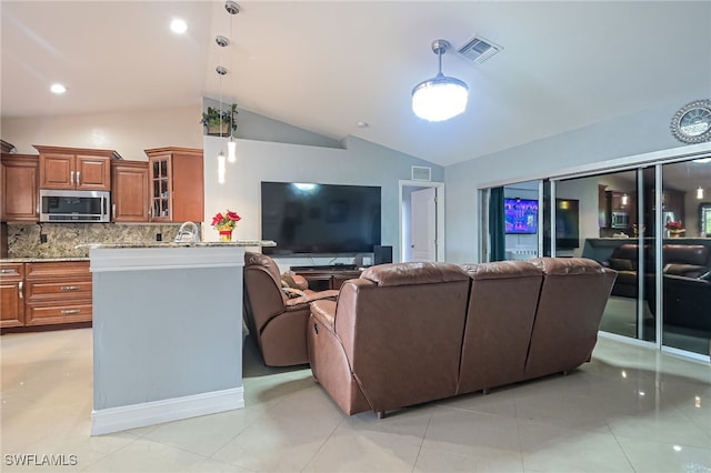 living room featuring light tile patterned flooring and lofted ceiling