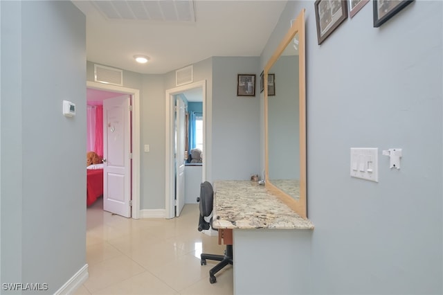 hallway featuring light tile patterned floors