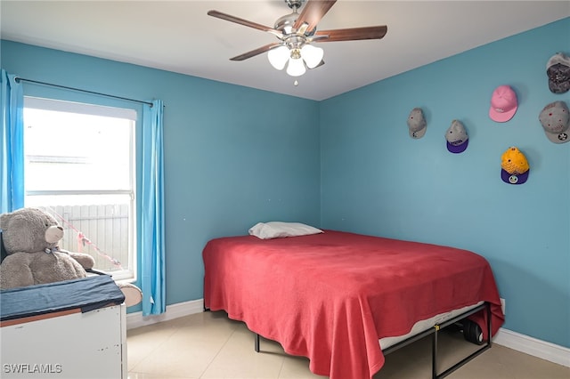 bedroom featuring light tile patterned floors, multiple windows, and ceiling fan