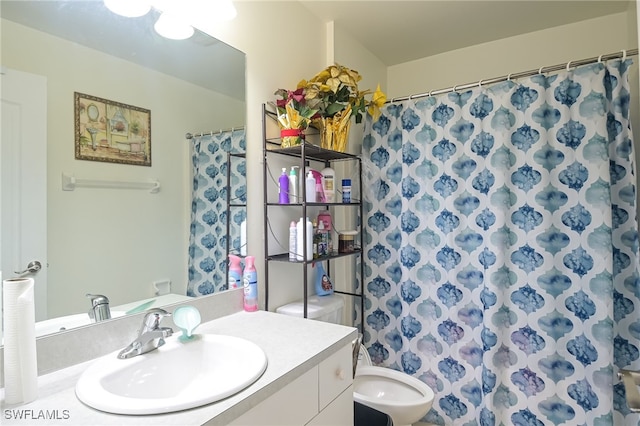 bathroom featuring a shower with curtain, vanity, and toilet