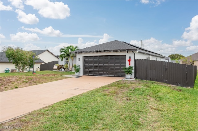 view of front of property with a front yard and a garage