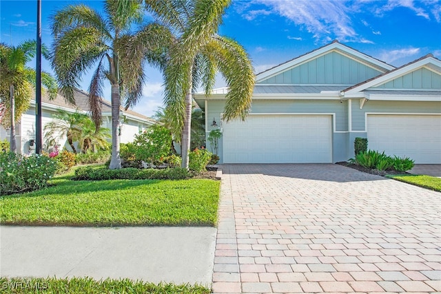 view of front of house with a front yard and a garage