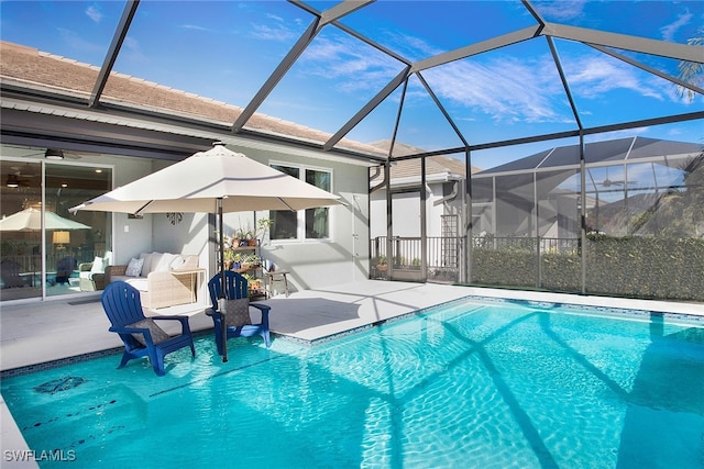 view of swimming pool with a patio area and glass enclosure