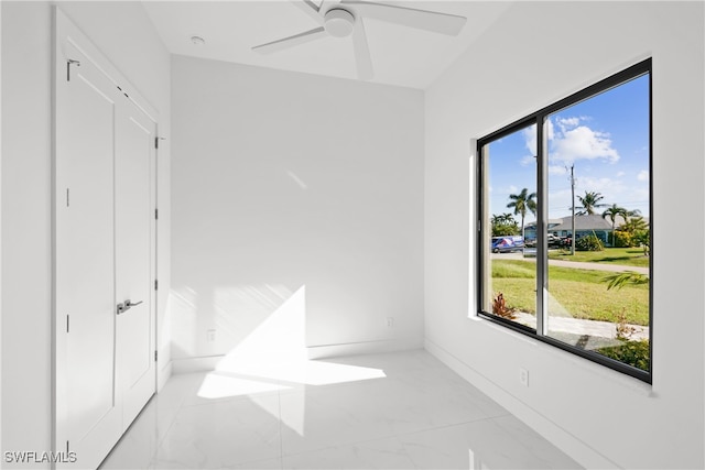 bedroom with ceiling fan and multiple windows