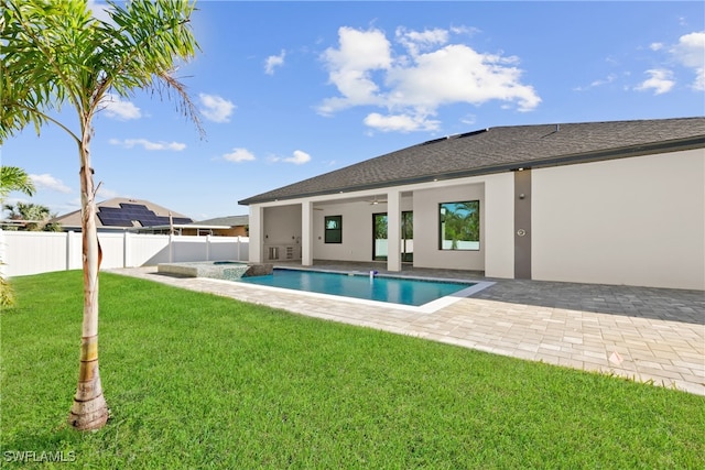 view of pool with a lawn and a patio area