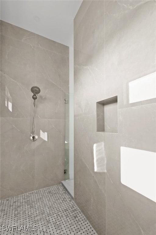 bathroom with tiled shower