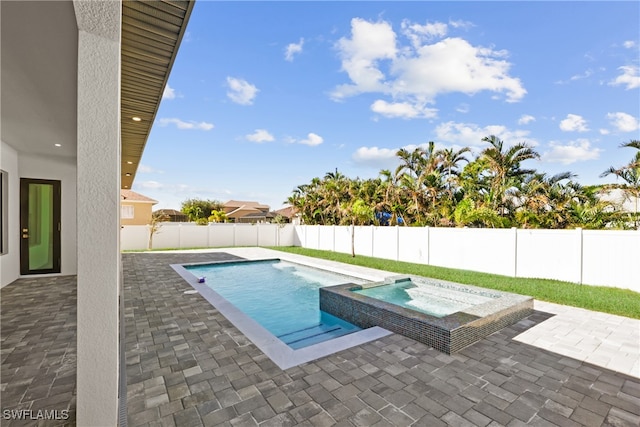 view of pool with a patio area and an in ground hot tub