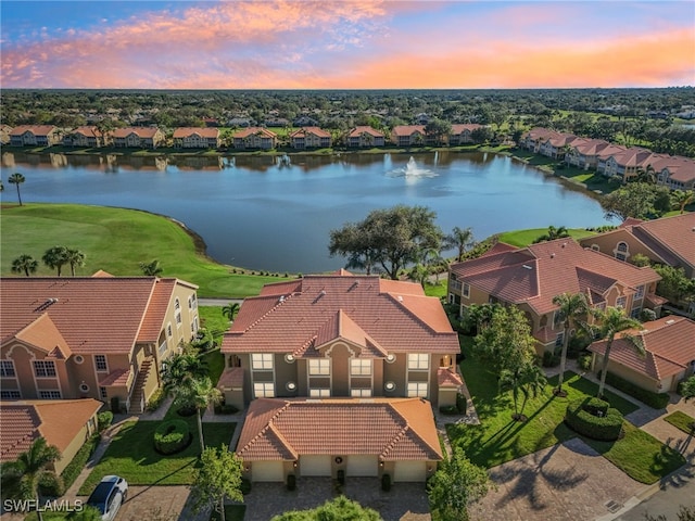 aerial view at dusk with a water view