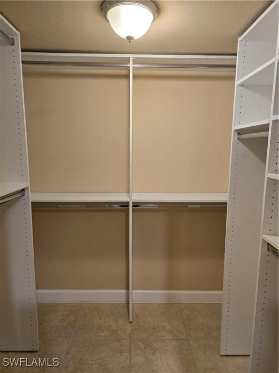 spacious closet featuring light tile patterned flooring