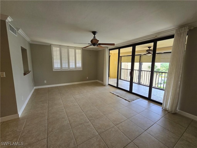 tiled spare room with expansive windows, ceiling fan, ornamental molding, and a wealth of natural light