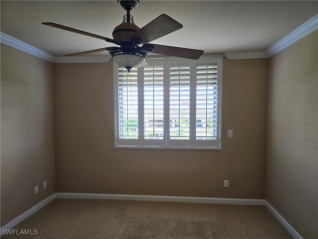 carpeted spare room with crown molding and ceiling fan